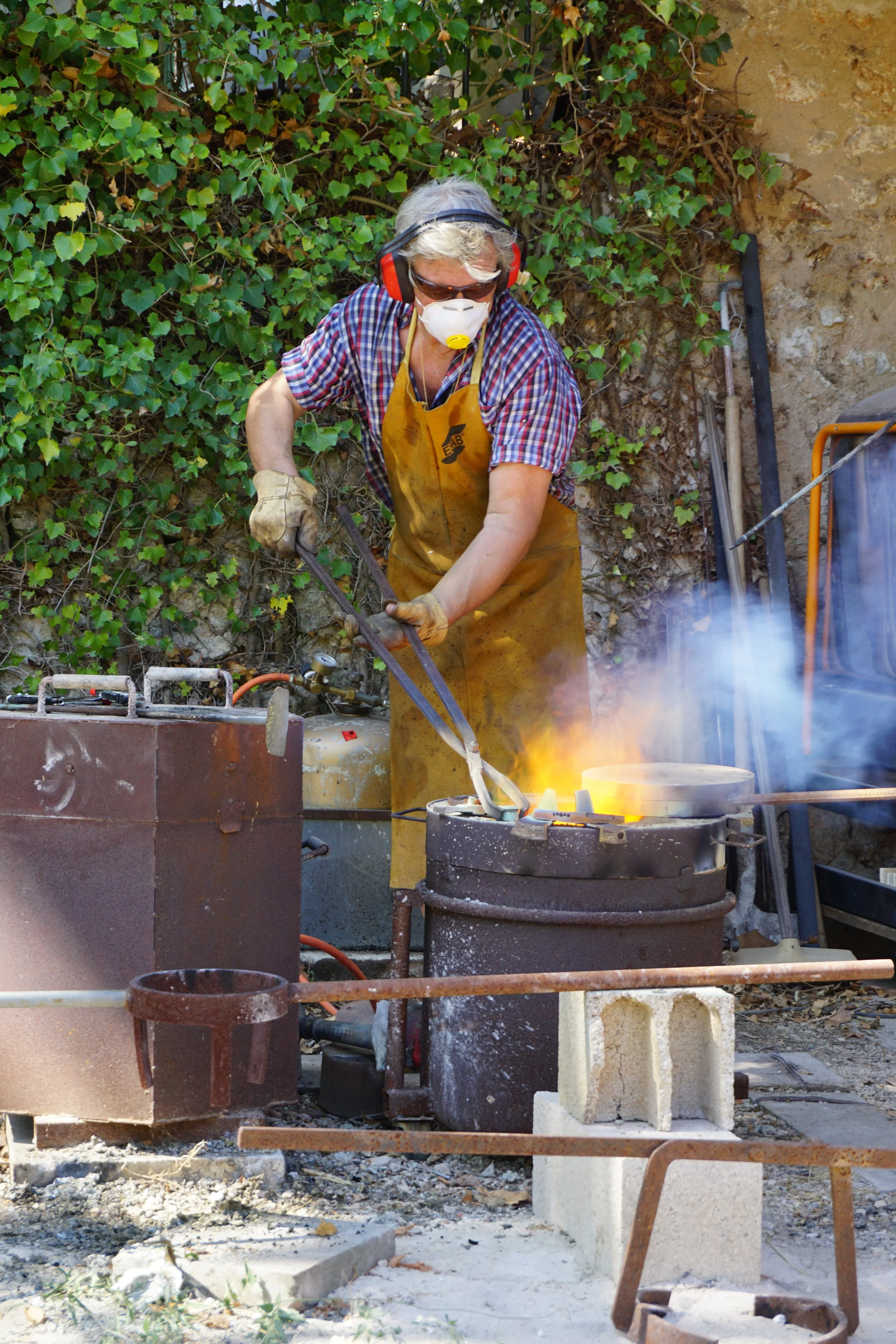 Serge's father adding metal in to be smelted